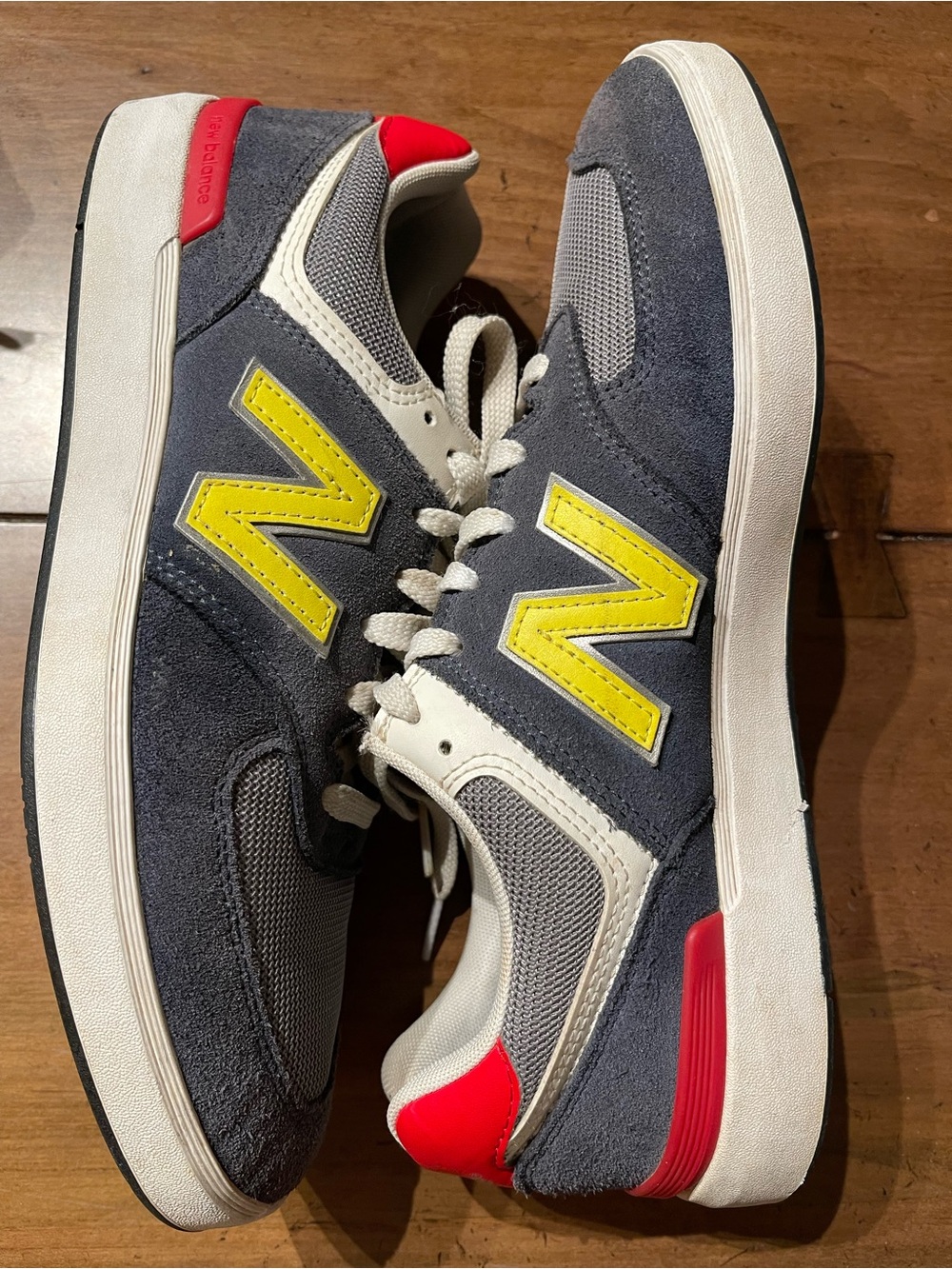 New Balance Men's Gray Suede Sneakers with Yellow N and Red Heel Accents